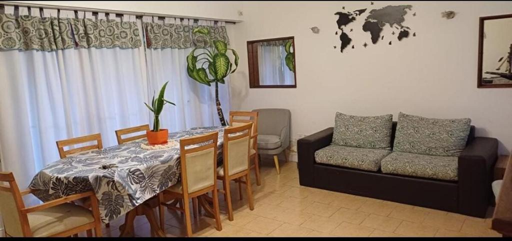 a living room with a table and a couch at Casa Chauvin con pileta in Mar del Plata