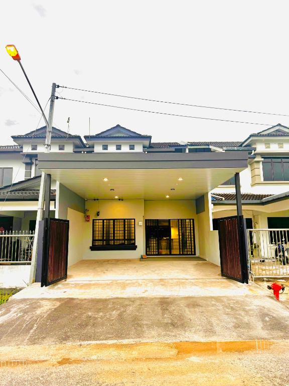 a large white house with a large driveway at HMHome-Seven in Sibu