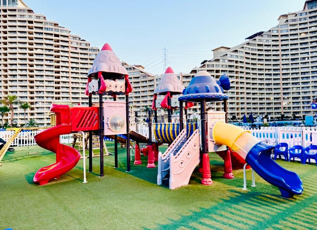 a playground with colorful slides and slides at Amer Group Villas and Chalets on the Pool in Ain Sokhna