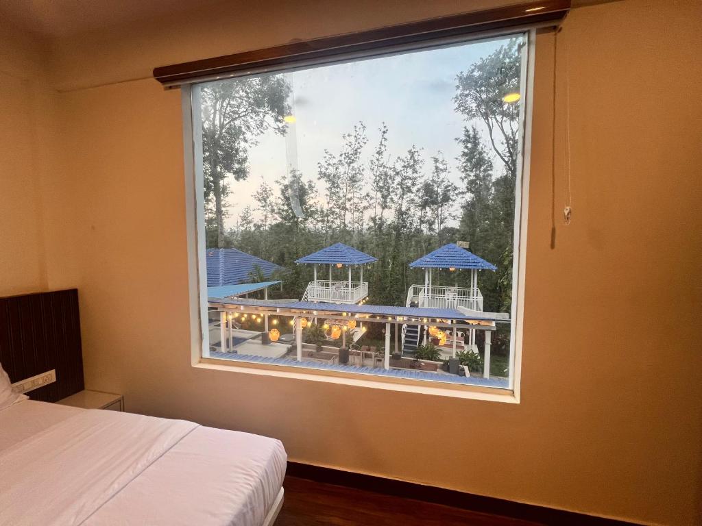 a bedroom window with a view of a patio at Aetheria Estate Retreat in Chikmagalūr