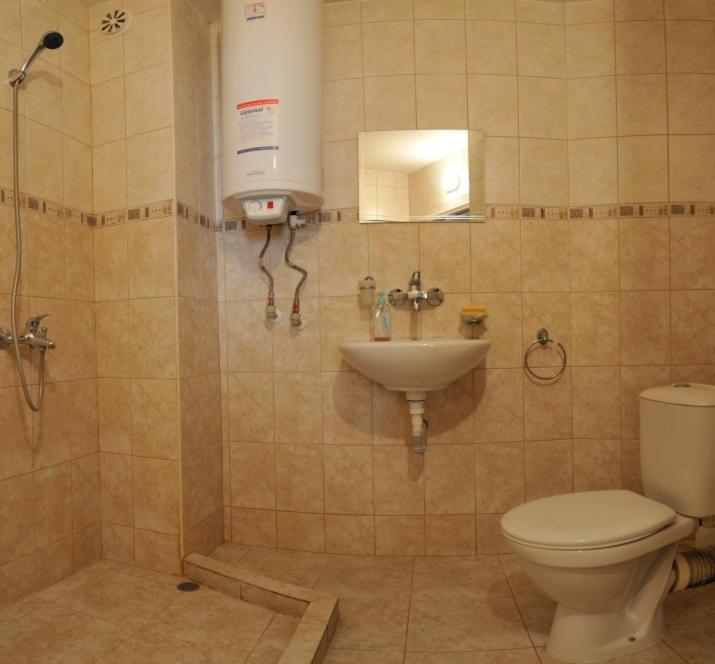 a bathroom with a toilet and a sink at Family Hotel Prolet in Shumen