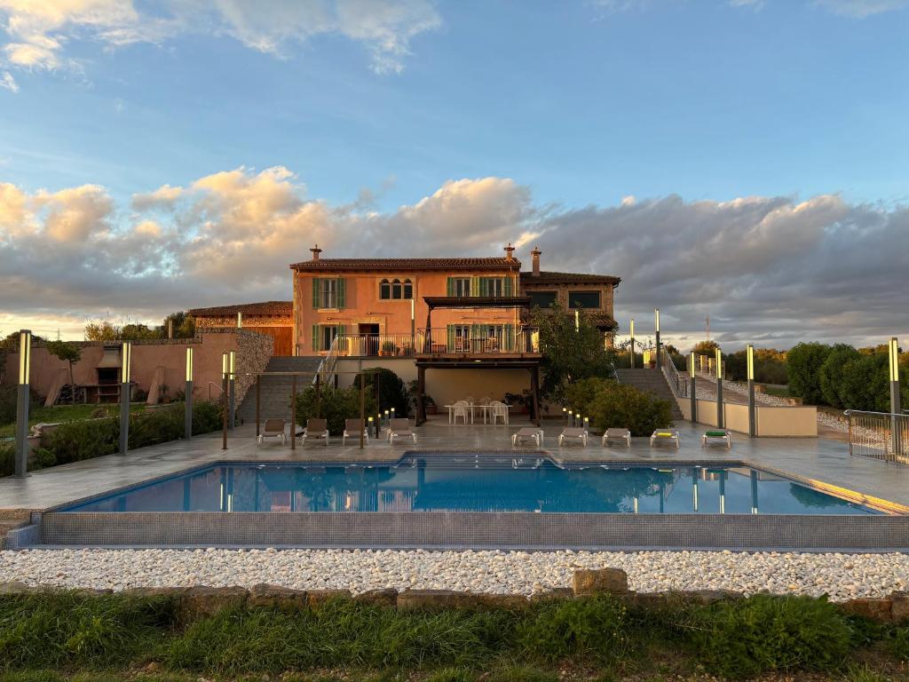 a house with a swimming pool in front of a house at Villa Sa Muntanyeta con Piscina Infinity Privada in Manacor