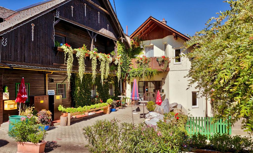 a courtyard of a building with flowers and plants at Gasthof Kranerwirt in Lannach