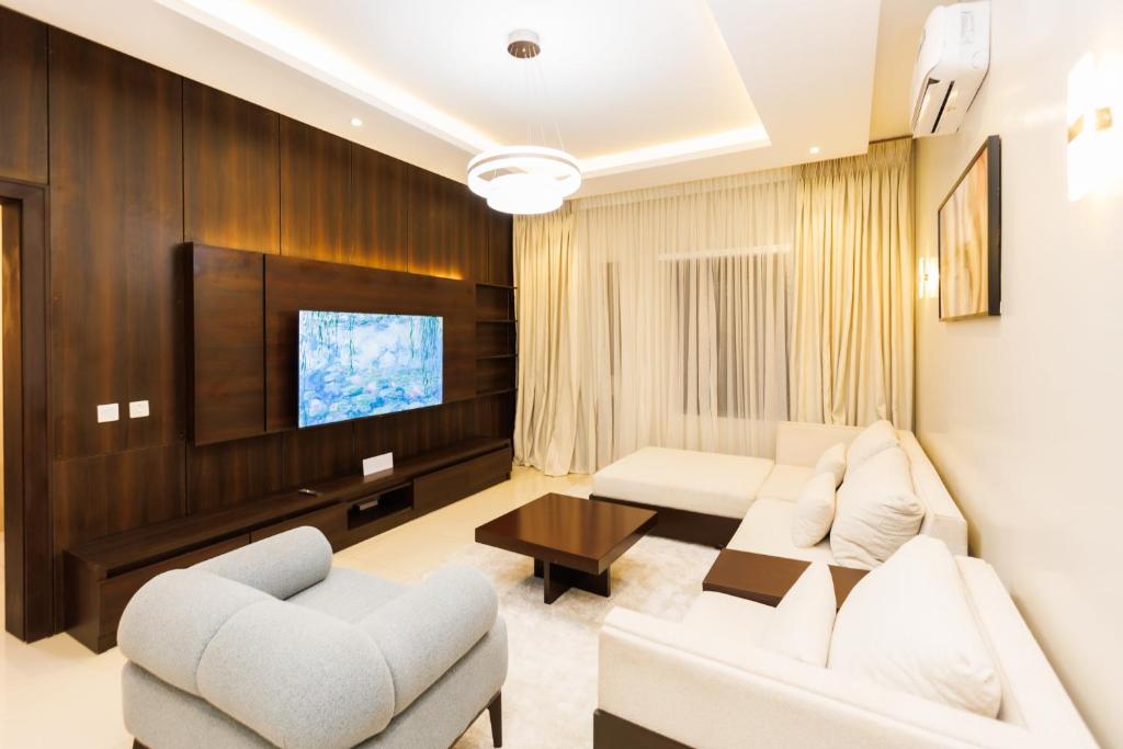 a living room with a couch and a tv at Mozabella Apartment in Karsana