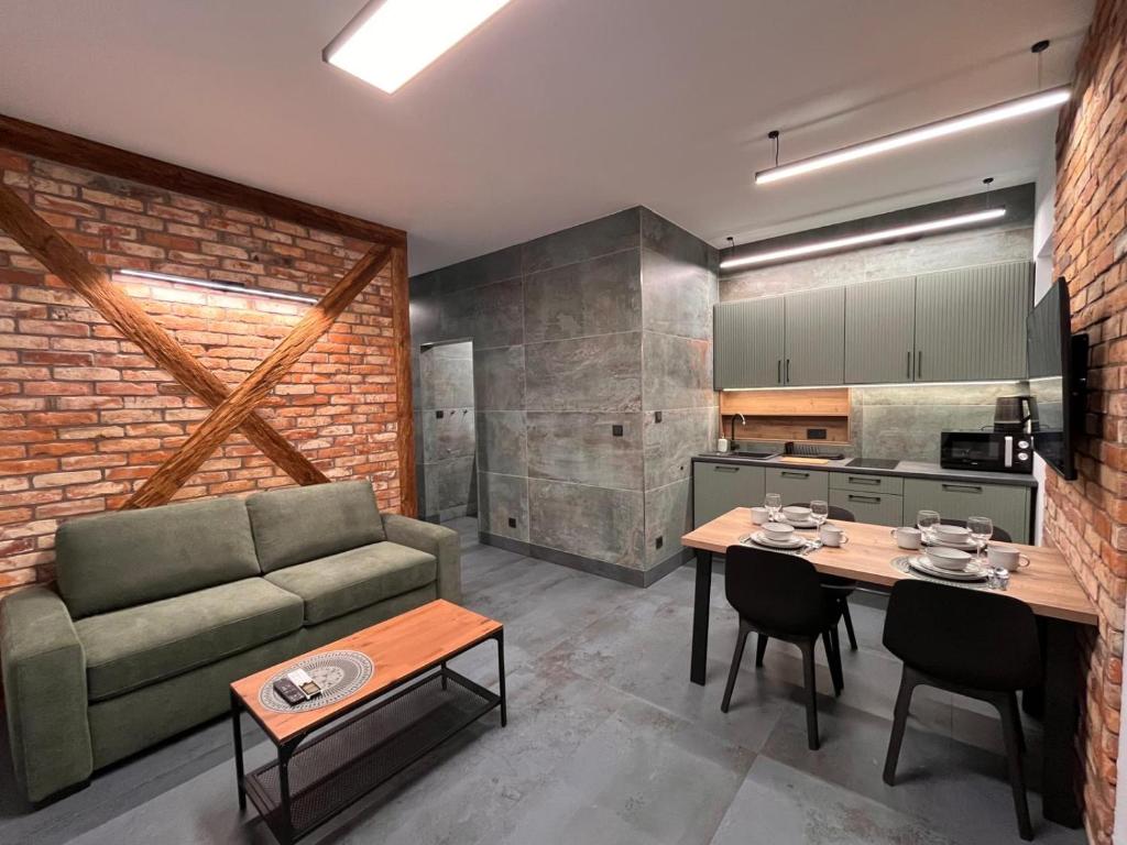 a living room with a couch and a table at Pod Palmami in Hel