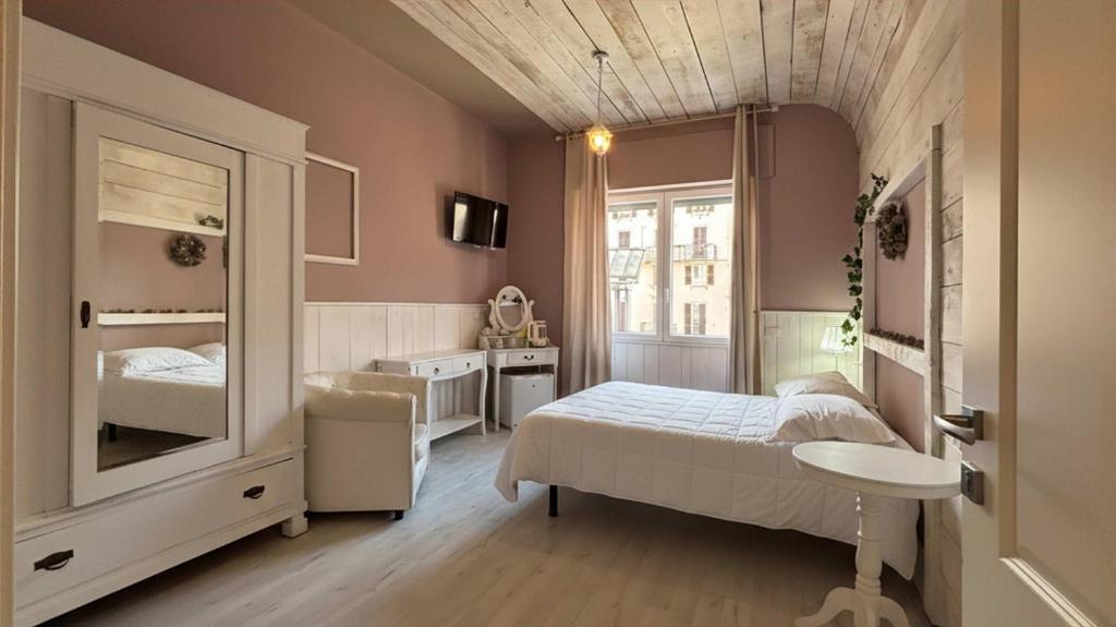 a bedroom with a bed and a sink and a window at Romantic - Affitti Brevi Italia in Lecco