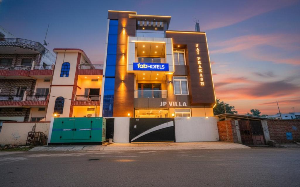 a building with a sign on the front of it at FabExpress JP Villa - Stadium in Varanasi