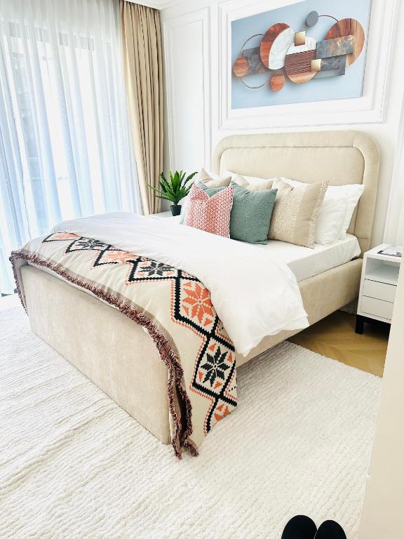 a bedroom with a large bed with pillows on it at TheEJResidence- 2Bedroom All Ensuite- 7km from JKIA 3km from SGR and Expressway along Mombasa Road-Nairobi Kenya in Nairobi