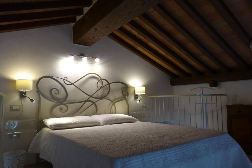 Łóżko lub łóżka w pokoju w obiekcie Relais Pacinotti Apartments