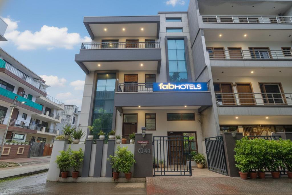a building with a sign that reads ko hotels at FabHotel Golf Luxury- 10 Min From Sector 42-43 Rapid Metro Station in Gurgaon