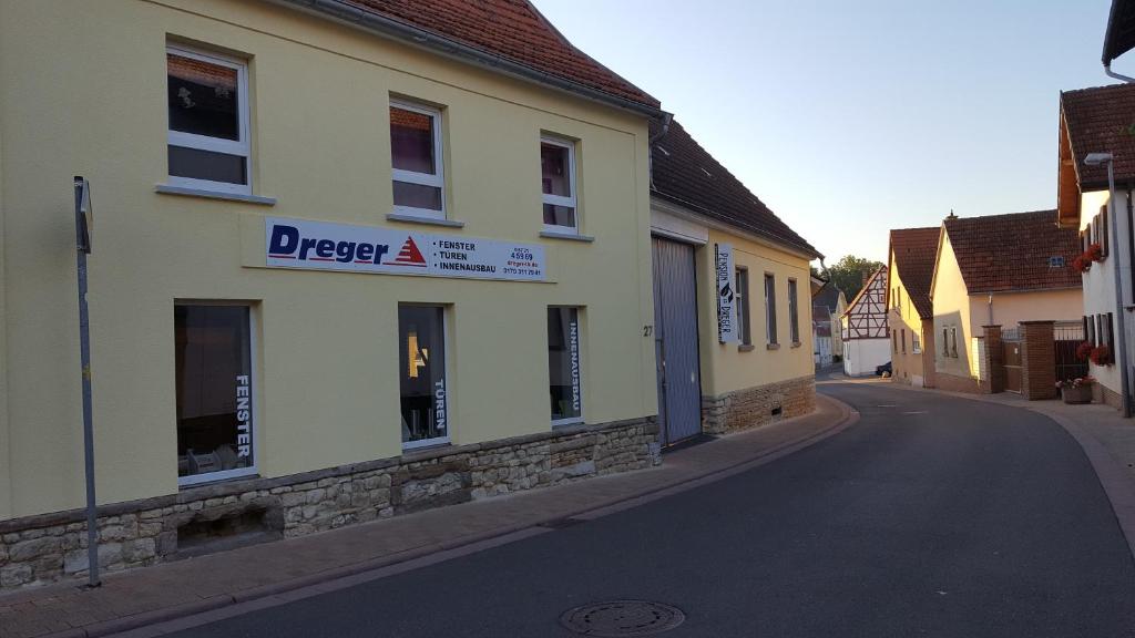 a building with a sign on the side of a street at Pension Dreger in Freimersheim