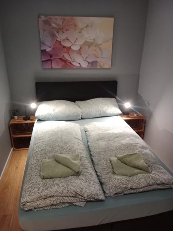 a bedroom with a bed with two pillows on it at Stadtnah an der Förde 5705 in Flensburg