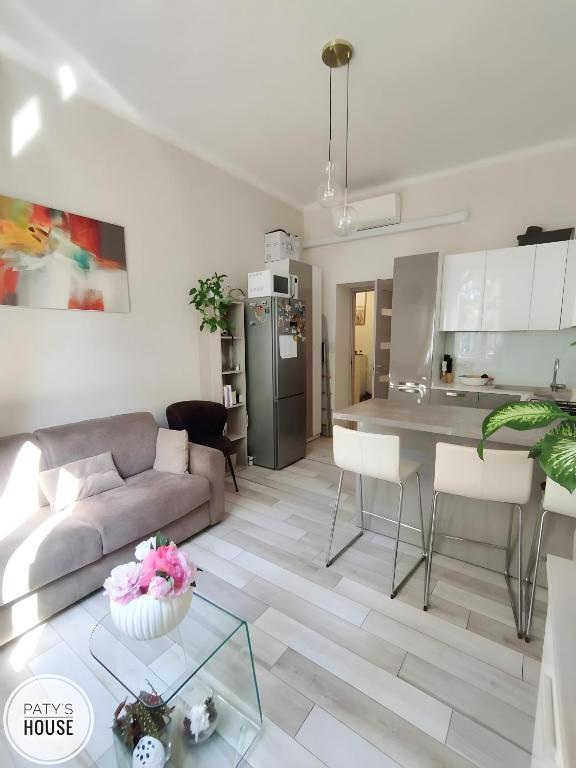 a living room with a couch and a table at Paty's House Milano in Milan