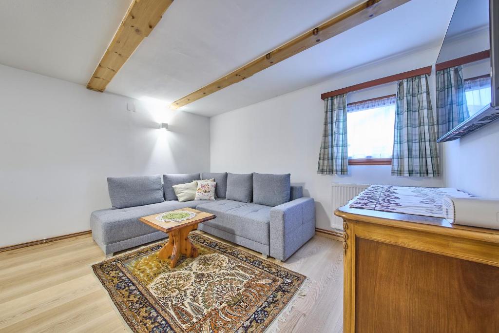 a living room with a couch and a table at Haus Erni in Bad Aussee