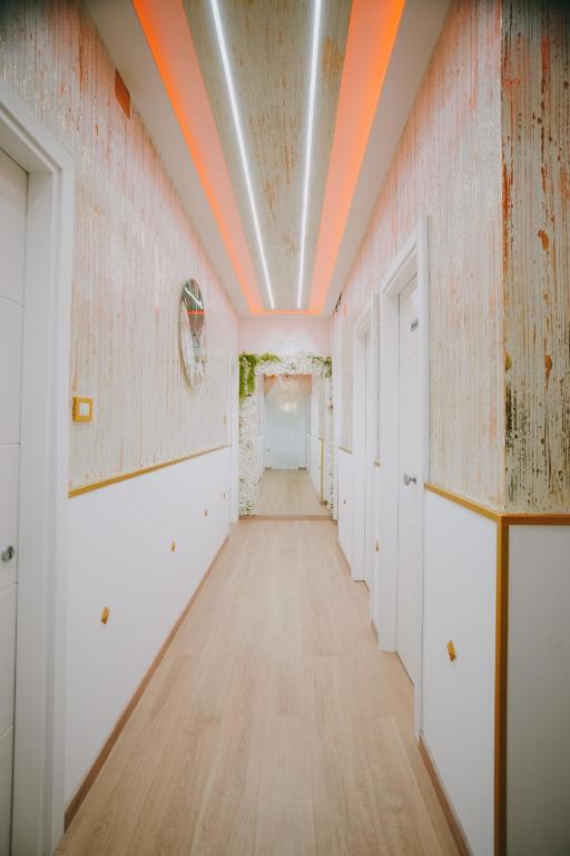 an empty hallway with an orange line on the ceiling at Cama Luxury Rooms in Palermo