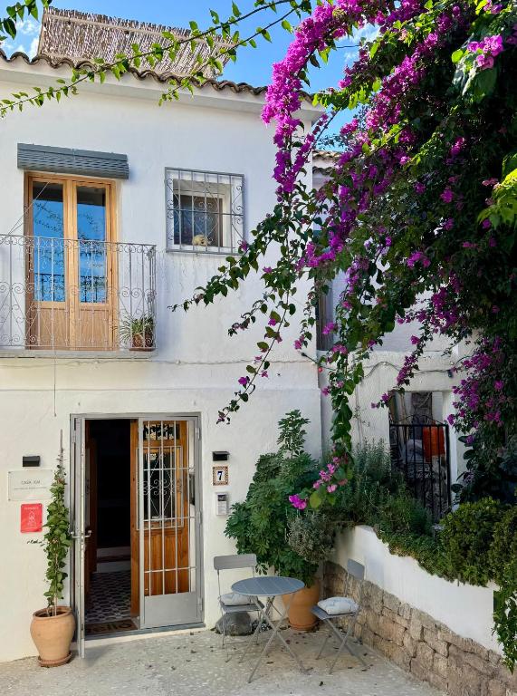 a white house with purple flowers in front of it at Casa Kai Altea - Torre de Bellaguarda in Altea