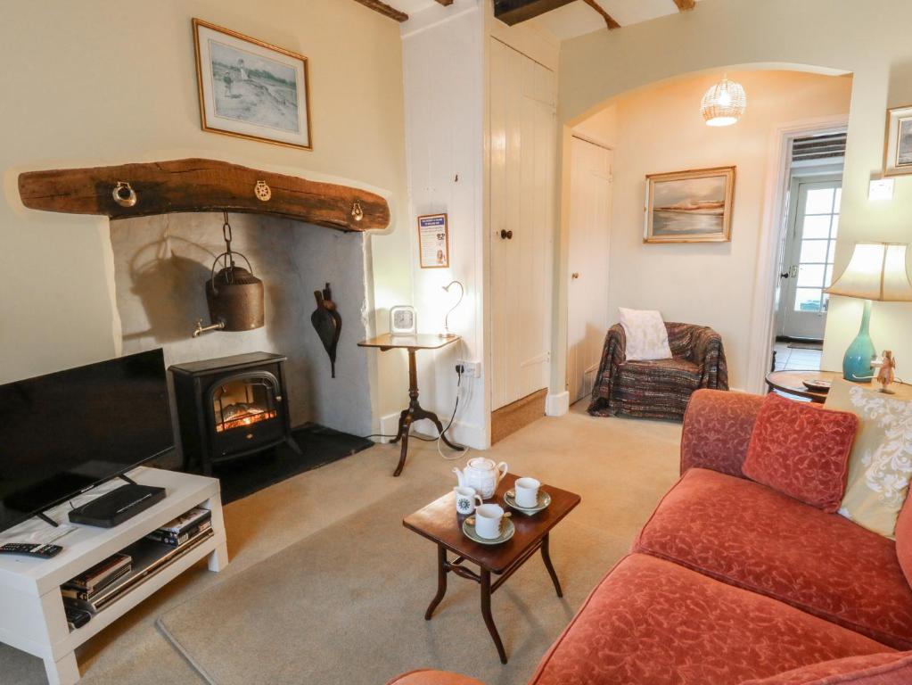 a living room with a couch and a fireplace at 6 Church Lane in Llanidloes