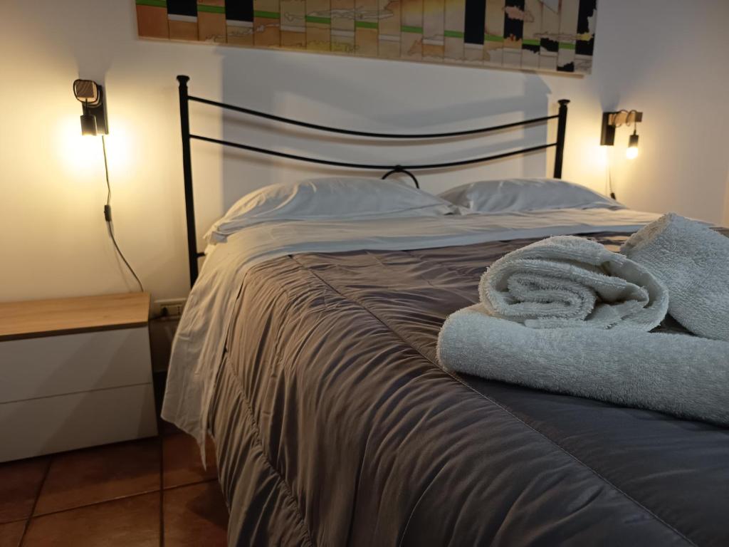 un letto con due asciugamani sopra in una camera da letto di Il canneto a Catania