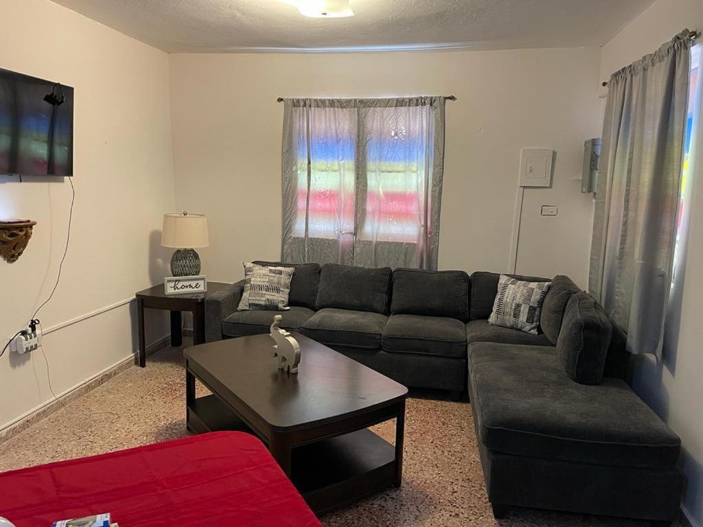 a living room with a couch and a coffee table at Aguada Get Away Apartment 