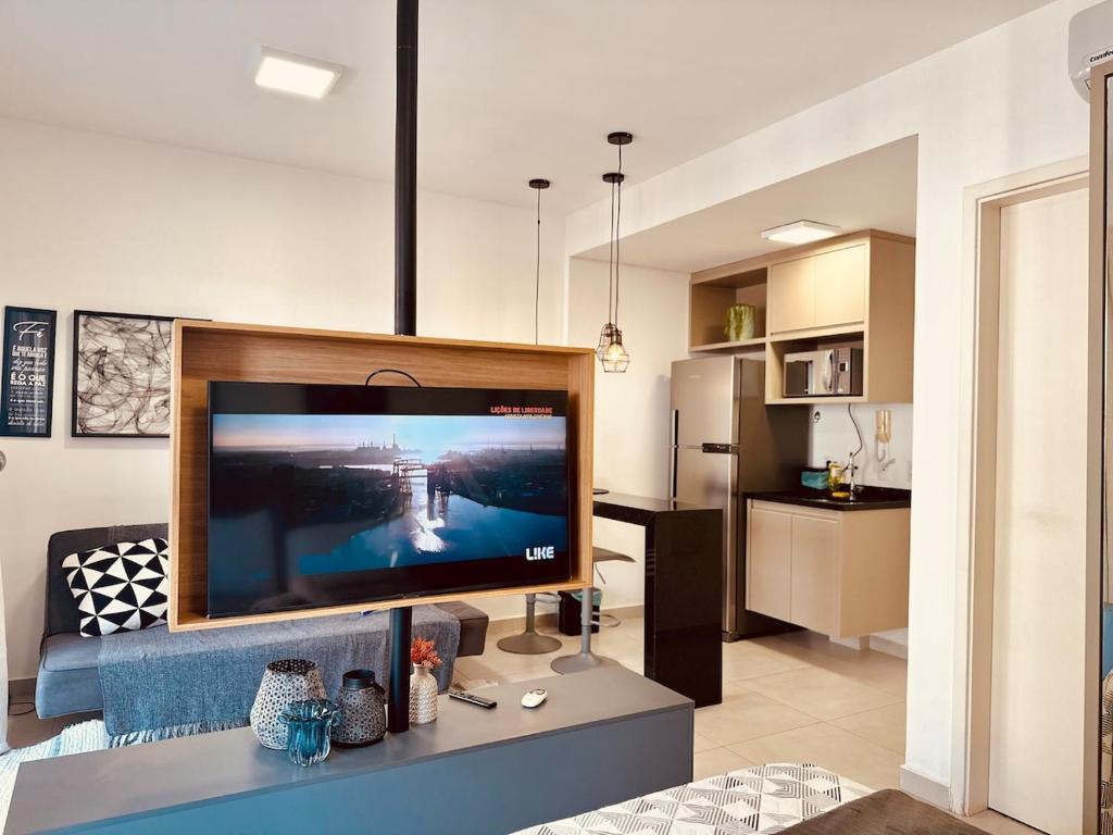 a living room with a large flat screen tv at Madrid 1101 in Sao Jose do Rio Preto