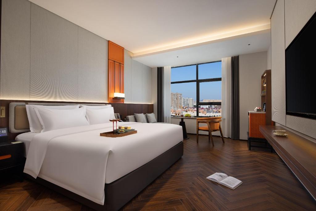 Ένα ή περισσότερα κρεβάτια σε δωμάτιο στο Yuezhi Hotel Liuyang Tianhong Shopping Center Branch