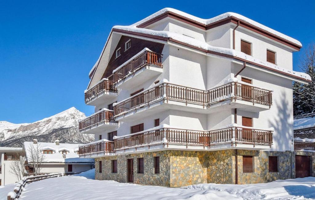 a snow covered building with balconies on it at Casa Maria Grazia in Sauze dʼOulx