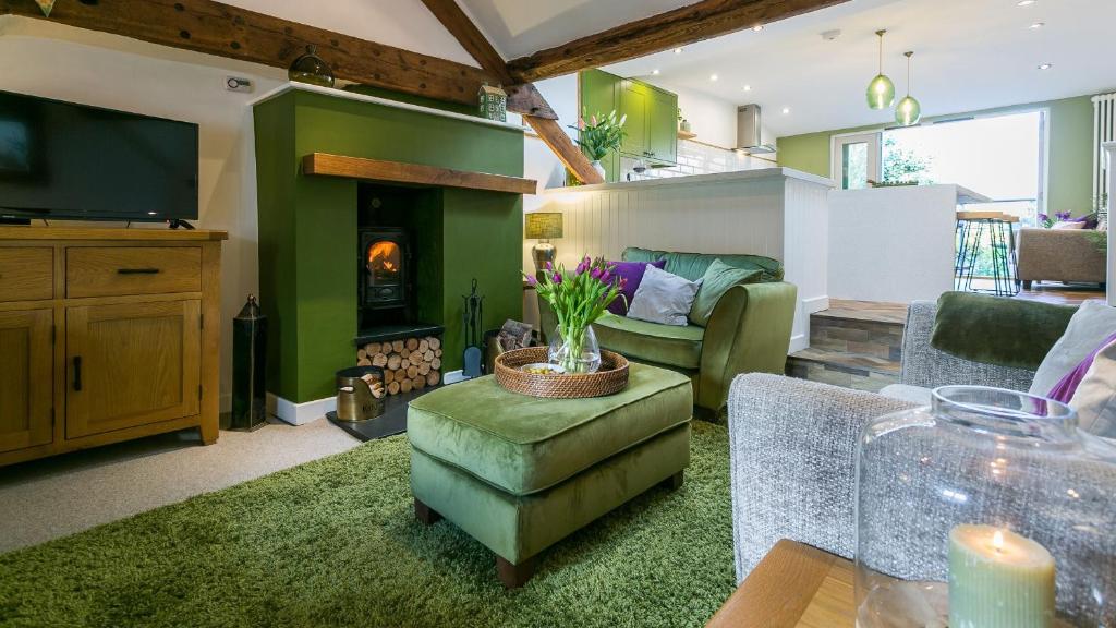 a living room with a couch and a fireplace at Hafan in Beaumaris