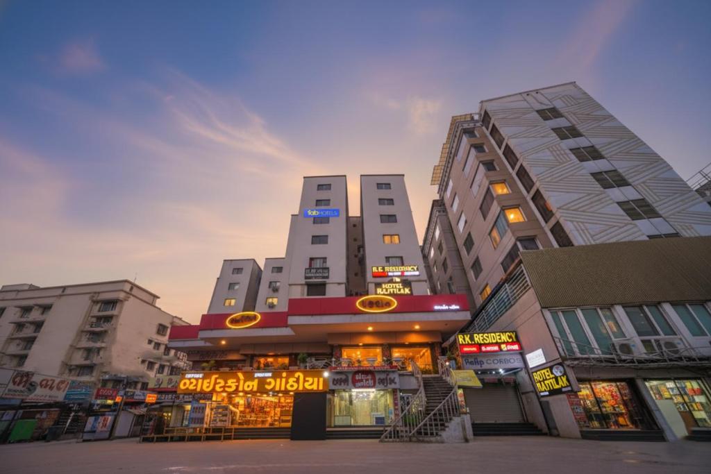 a street with tall buildings in a city at FabHotel Rajtilak in Ahmedabad