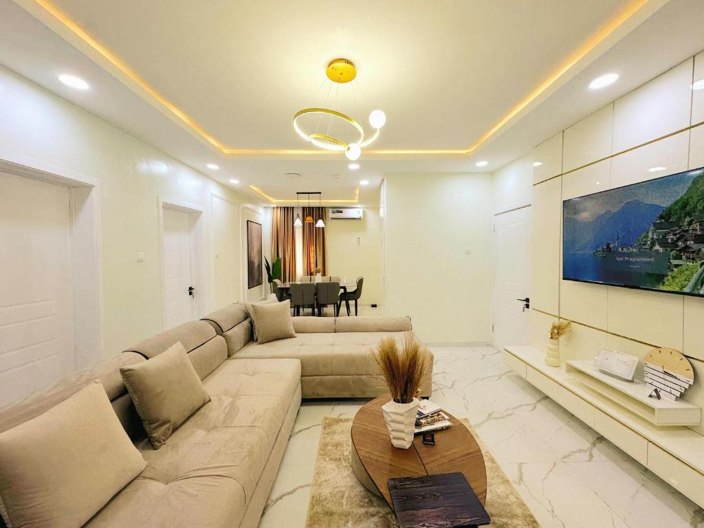 a living room with a couch and a table at LinQues & Bethel Residences in Ibadan
