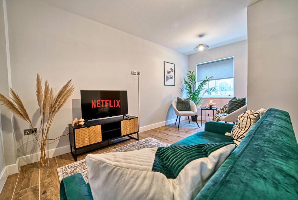 a living room with a couch and a tv at Central and Stylish, Garden and Parking in Coventry