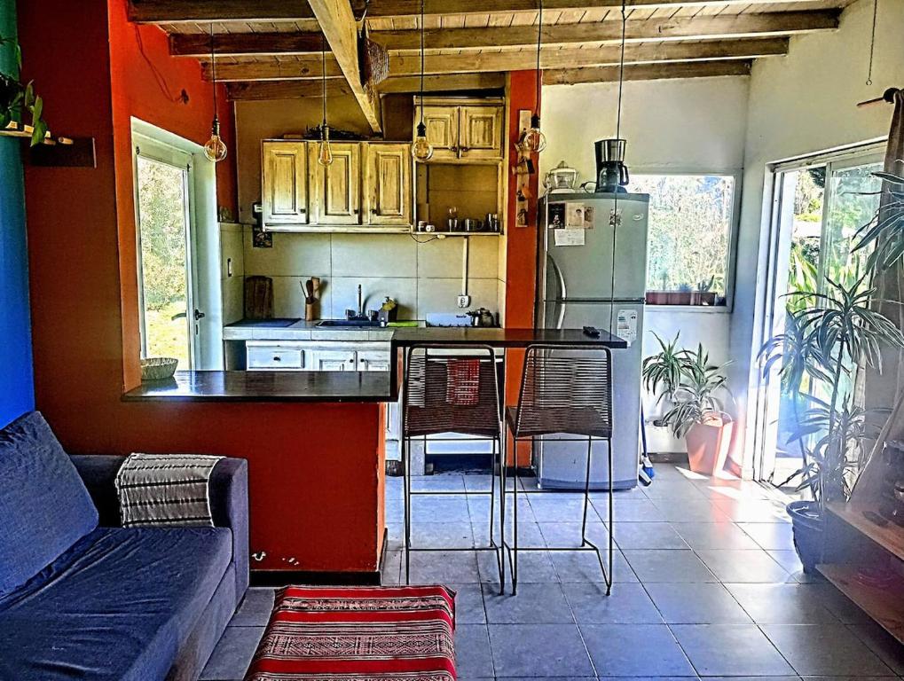 a kitchen with a couch and a table in a room at La Maruja de Acantilados in Mar del Plata