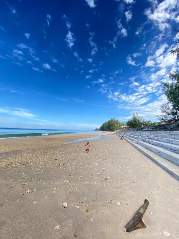 a view of a beach with a stick in the sand at Baan Amila in Phra Ae beach