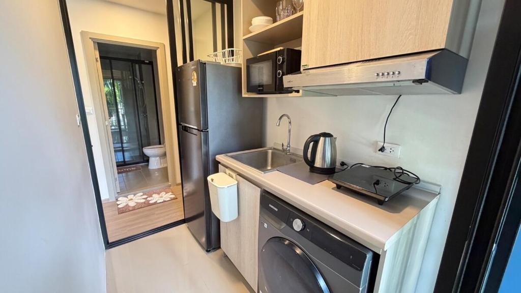 a small kitchen with a sink and a refrigerator at DCondo Kathu ใกล้หาดป่าตอง in Kathu