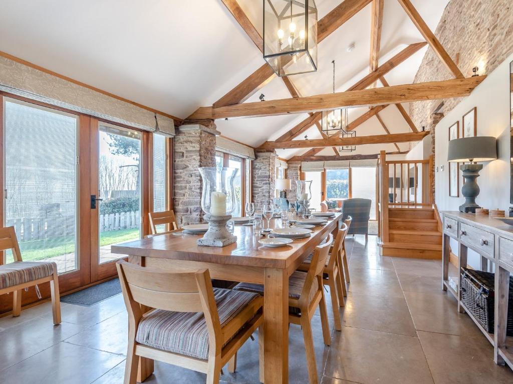 a dining room with a long wooden table and chairs at 3 Bed in Leominster 50517 in Pencombe
