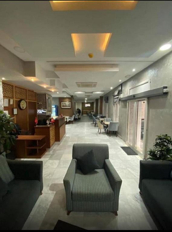 a lobby with couches and chairs in a building at Hôtel EDHIAFA in Al Madīnah