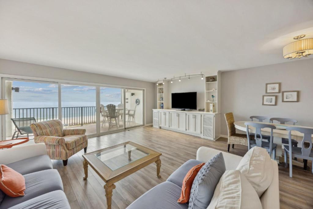 a living room with a view of the ocean at Beach Cottage Look Condo, Ocean View from Spacious Balcony in Fernandina Beach