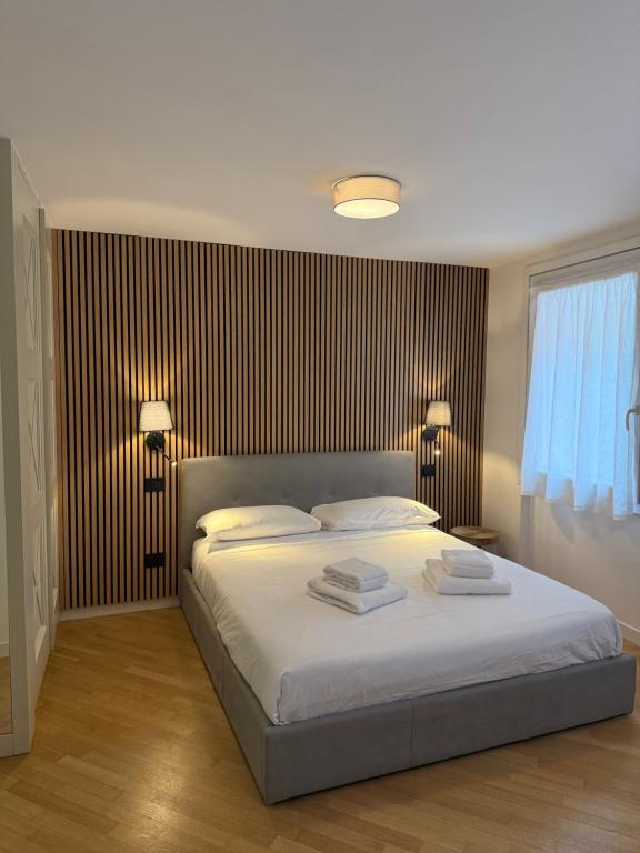 a bedroom with a bed with two towels on it at Appartamenti Anna in Sirmione