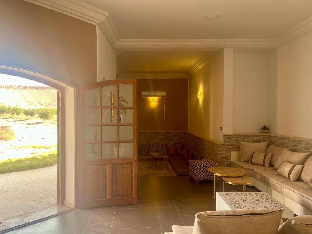 un soggiorno con un divano e un tavolo di Magnifique villa alliant tradition et modernité en plein oliveraie 