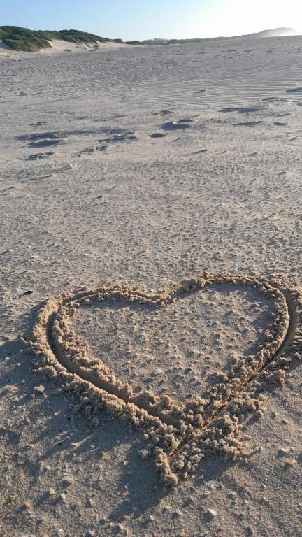 a heart drawn in the sand on a beach at Sunbird 2 in Cape St Francis