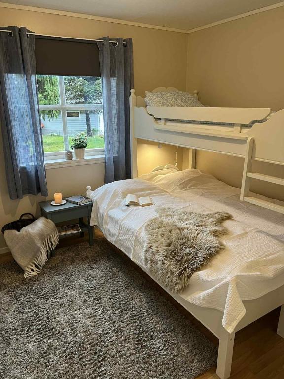 a bedroom with a bunk bed with a furry blanket at Cozy Central Apartment - Free Parking & Wifi in Vossevangen