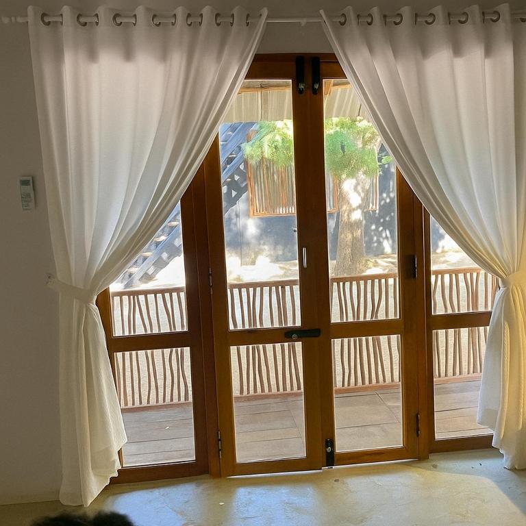 an open door with curtains in a room at Jungle Trails in Sigiriya