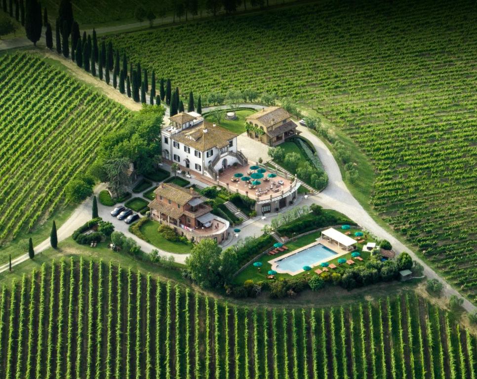 an aerial view of a mansion in a vineyard at Poggio al Casone in Crespina