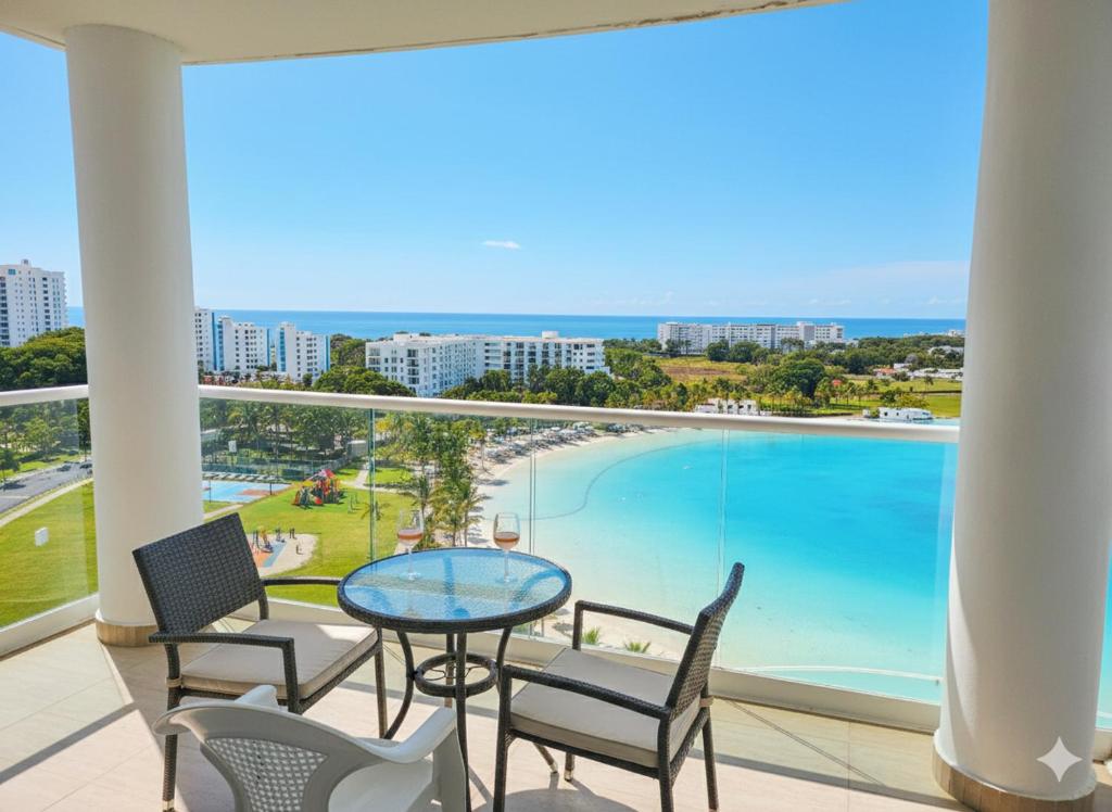 a balcony with a table and chairs and a pool at Luz de Laguna in Playa Blanca
