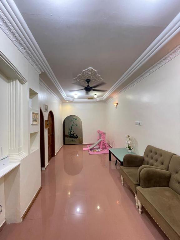 a living room with a couch and a table at IF Homestay Mersing in Mersing