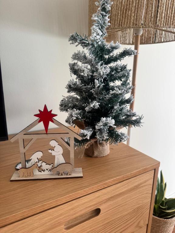 a christmas tree on top of a dresser with a christmas decoration at Serene Coastal Retreat with king Beds & Pool in Lavra in Lavra