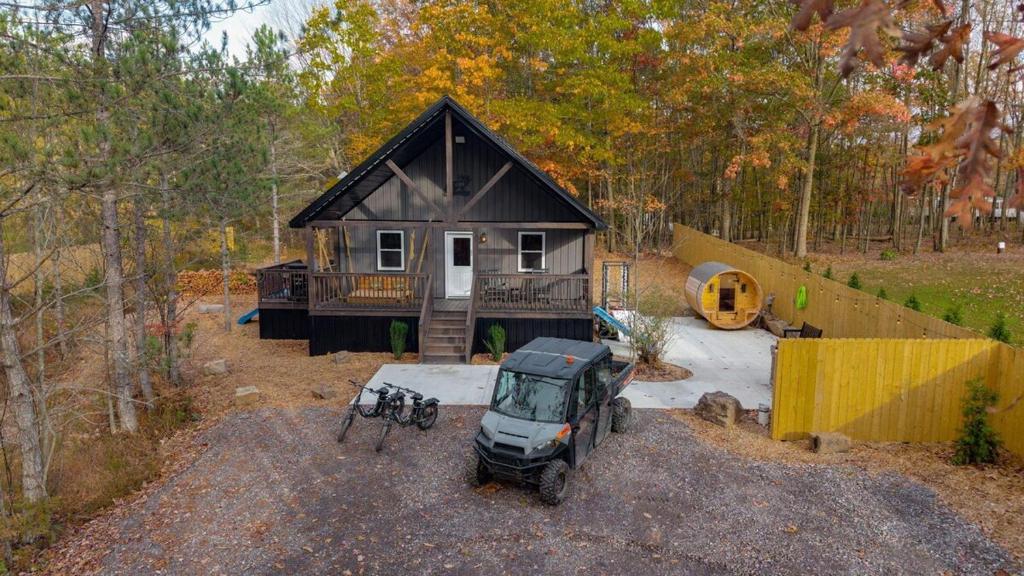 a small house with a jeep parked in front of it at The Elk Camp in Benezette