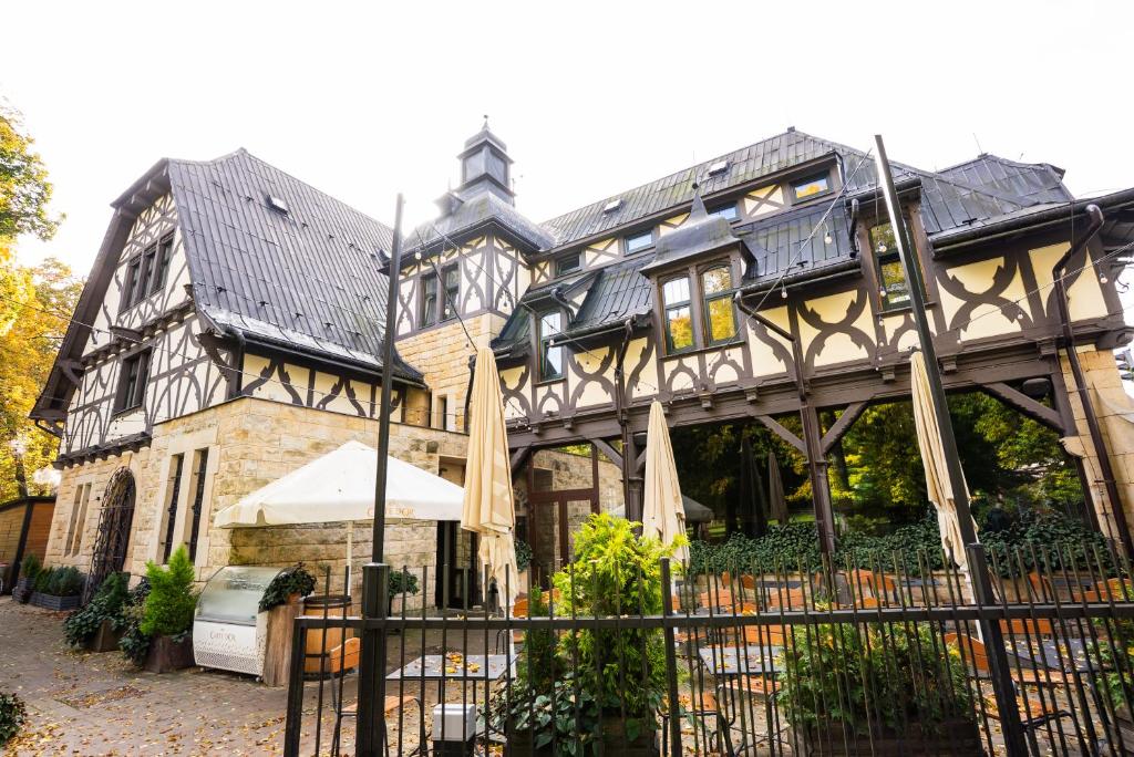 an old house with a gate in front of it at Zámecká Konírna Hotel a Restaurace in Liberec