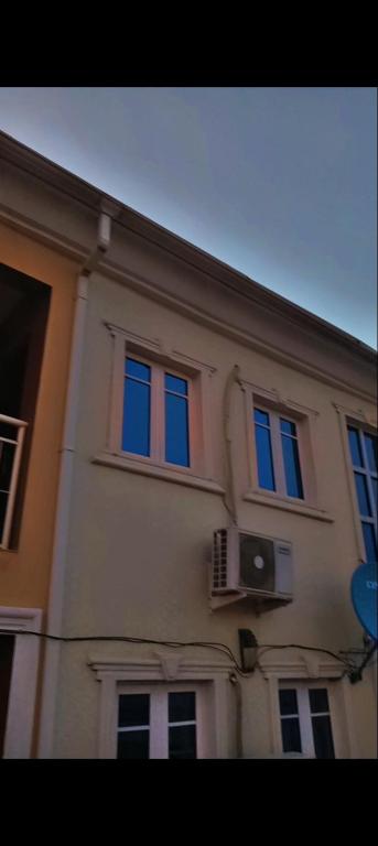 a building with windows on the side of it at Abasis apartment in Abeokuta