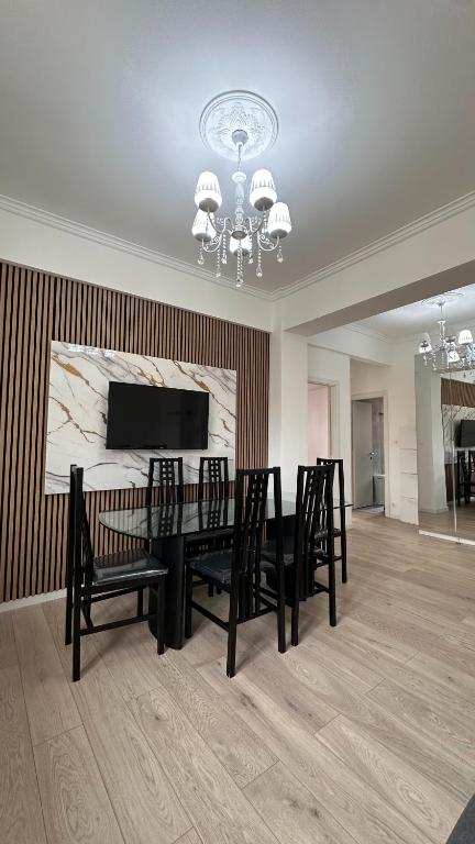 a dining room with a table and chairs and a chandelier at Casa di Tatiana in Chiappa