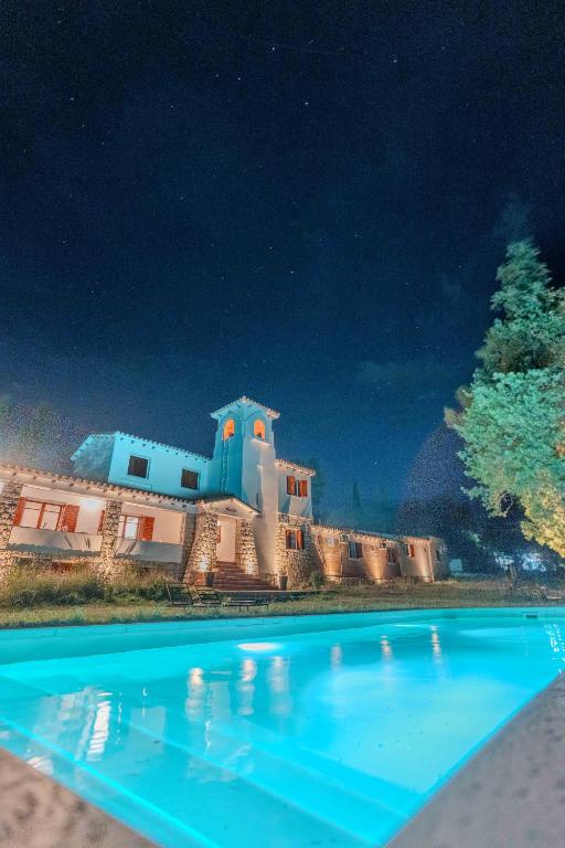 a pool in front of a house at night at Madaro House in San Antonio de Arredondo